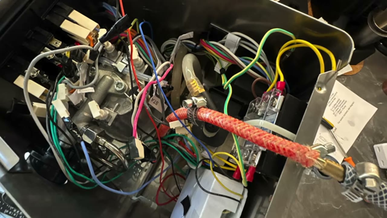 The opened Gaggia Classic showing its boiler, wiring and water circuit