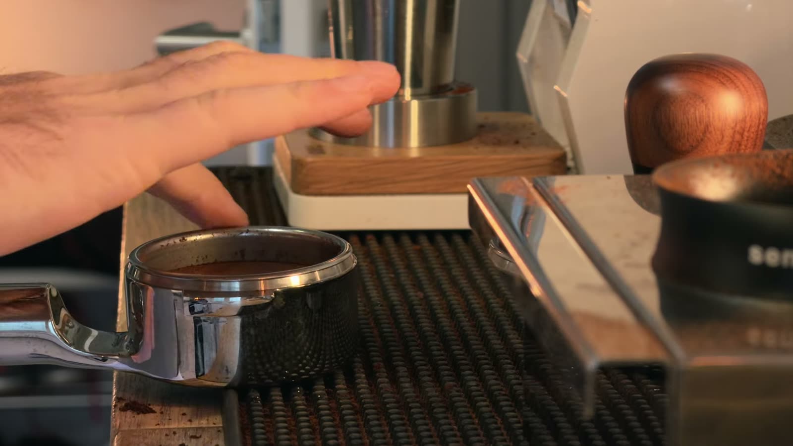 Mischief bottomless portafilter with a dosed Spirit high extraction basket on the drip tray of a Lelit Bianca